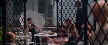 Movie still from “Klute” (1971), directed by Alan J. Pakula – A group of people sitting around a table; Wide shot, High angle