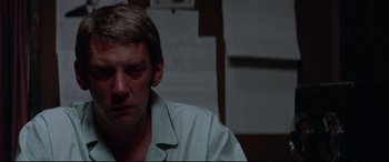 Movie still from “Klute” (1971), directed by Alan J. Pakula – A person wearing a white shirt; Close Up shot, Low angle