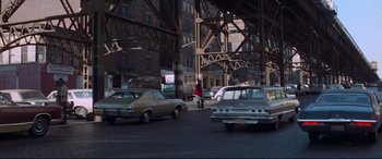 Movie still from “Klute” (1971), directed by Alan J. Pakula – A busy city street filled with cars and pedestrians; Extreme Wide shot, High angle