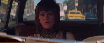 Movie still from “Klute” (1971), directed by Alan J. Pakula – A person wearing a necklace in a car; Close Up shot, Low angle