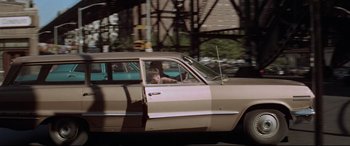Movie still from “Klute” (1971), directed by Alan J. Pakula – A woman sitting in the drivers seat of a car; Wide shot, High angle