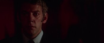 Movie still from “Klute” (1971), directed by Alan J. Pakula – A person wearing a suit and tie; Close Up shot, Low angle