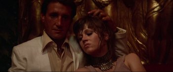 Movie still from “Klute” (1971), directed by Alan J. Pakula – A man and a woman are sitting together; Close Up shot, Low angle