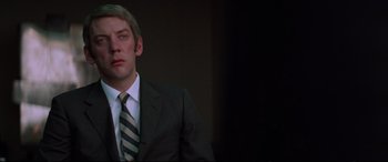 Movie still from “Klute” (1971), directed by Alan J. Pakula – A person wearing a suit and tie; Close Up shot, Low angle