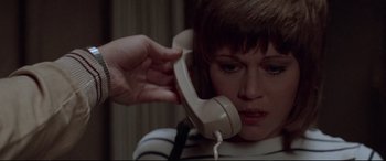 Movie still from “Klute” (1971), directed by Alan J. Pakula – A woman holding a phone up to her ear; Close Up shot, High angle