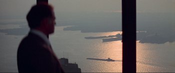 Movie still from “Klute” (1971), directed by Alan J. Pakula – Many ships in the water at sunset; Extreme Wide shot, Over the shoulder angle