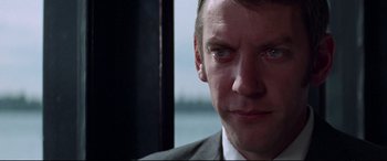 Movie still from “Klute” (1971), directed by Alan J. Pakula – A person wearing a suit and tie; Close Up shot, Over the shoulder angle