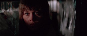 Movie still from “Klute” (1971), directed by Alan J. Pakula – A person's face in the dark; Close Up shot, Low angle