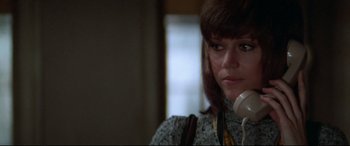 Movie still from “Klute” (1971), directed by Alan J. Pakula – A person talking on a phone; Close Up shot, Low angle