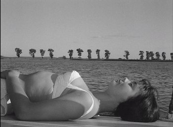 Movie still from “Knife in the Water” (1962), directed by Roman Polanski – A black and white photo of a woman laying on a boat; Medium shot, Low angle