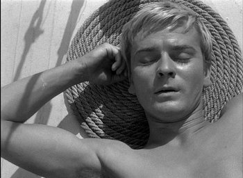Movie still from “Knife in the Water” (1962), directed by Roman Polanski – A man laying in a hammock with his eyes closed; Close Up shot, Overhead angle