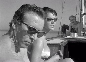 Movie still from “Knife in the Water” (1962), directed by Roman Polanski – A black and white photo of a man and a woman sitting at a table; Close Up shot, Low angle