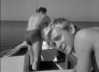Movie still from “Knife in the Water” (1962), directed by Roman Polanski – Two men on a boat in the water; Medium shot, Low angle