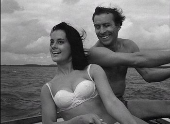 Movie still from “Knife in the Water” (1962), directed by Roman Polanski – A man and a woman in the water on a boat; Medium shot, Low angle
