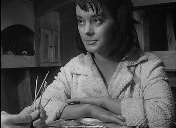 Movie still from “Knife in the Water” (1962), directed by Roman Polanski – A black and white photo of a woman holding toothpicks; Close Up shot, High angle