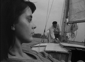 Movie still from “Knife in the Water” (1962), directed by Roman Polanski – A man and a woman on a sailboat in the water; Close Up shot, High angle