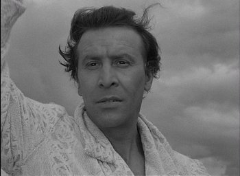 Movie still from “Knife in the Water” (1962), directed by Roman Polanski – A black and white photo of a man in a robe; Close Up shot, Low angle
