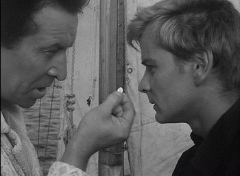 Movie still from “Knife in the Water” (1962), directed by Roman Polanski – A man and a woman looking at each other; Close Up shot, Over the shoulder angle