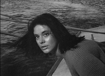 Movie still from “Knife in the Water” (1962), directed by Roman Polanski – Black and white photograph of a woman in a boat; Close Up shot, High angle