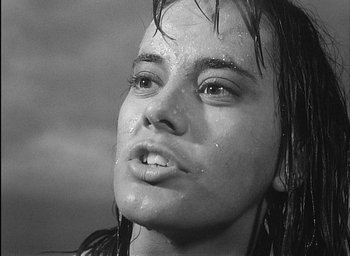 Movie still from “Knife in the Water” (1962), directed by Roman Polanski – A young woman with wet hair and a wet face; Close Up shot, Low angle