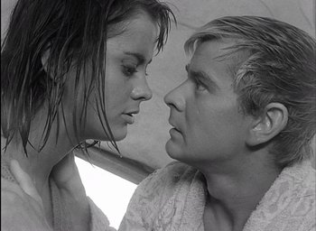 Movie still from “Knife in the Water” (1962), directed by Roman Polanski – A man and a woman looking at each other; Close Up shot, High angle