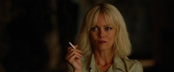 A woman holding a cigarette in her right hand
