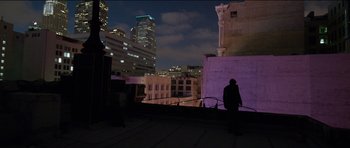 Movie still from “Knight of Cups” (2015), directed by Terrence Malick – A person standing on a roof top at night; Extreme Wide shot, Low angle