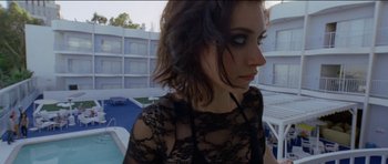 Movie still from “Knight of Cups” (2015), directed by Terrence Malick – A person wearing a dress near a swimming pool; Close Up shot, Overhead angle