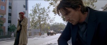 Movie still from “Knight of Cups” (2015), directed by Terrence Malick – A man sitting on the side of the road looking down; Close Up shot, Low angle