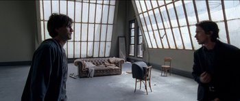 Movie still from “Knight of Cups” (2015), directed by Terrence Malick – An empty living room with a couch , chair , and a mirror; Wide shot, Low angle