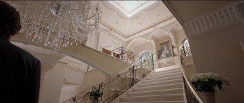 Movie still from “Knight of Cups” (2015), directed by Terrence Malick – A staircase with a chandelier and a painting on the top of the stairs; Extreme Wide shot, High angle