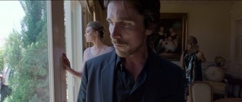 Movie still from “Knight of Cups” (2015), directed by Terrence Malick – A person wearing a suit and tie; Medium shot, Low angle