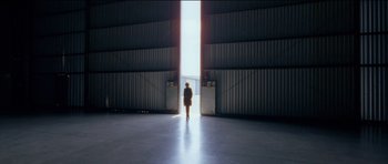 Movie still from “Knight of Cups” (2015), directed by Terrence Malick – A person standing in front of an opening in a building; Extreme Wide shot, Low angle