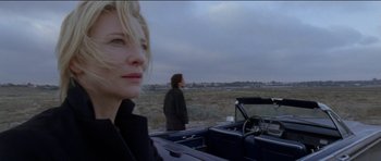 Movie still from “Knight of Cups” (2015), directed by Terrence Malick – A woman standing next to a man in a car; Close Up shot, Low angle