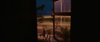 Movie still from “Knight of Cups” (2015), directed by Terrence Malick – Two people walking a dog down a sidewalk; Extreme Wide shot, High angle