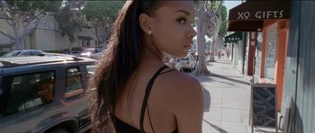 Movie still from “Knight of Cups” (2015), directed by Terrence Malick – A woman with long black hair standing on a sidewalk; Close Up shot, Low angle
