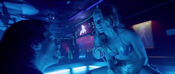 Movie still from “Knight of Cups” (2015), directed by Terrence Malick – A man and a woman are in a room with lights on; Medium shot, Low angle