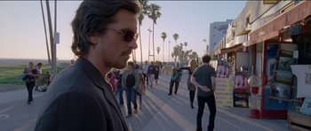 Movie still from “Knight of Cups” (2015), directed by Terrence Malick – A crowd of people walking down a sidewalk; Wide shot, Over the shoulder angle