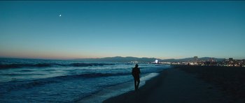 Movie still from “Knight of Cups” (2015), directed by Terrence Malick – A person walking on the beach at night; Extreme Wide shot, High angle