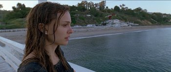 Movie still from “Knight of Cups” (2015), directed by Terrence Malick – A woman looking out over the water at the beach; Close Up shot, Low angle