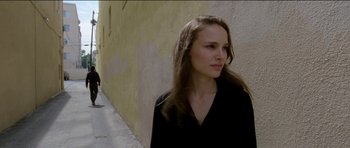 Movie still from “Knight of Cups” (2015), directed by Terrence Malick – A woman standing in front of a wall with her eyes closed; Close Up shot, Low angle
