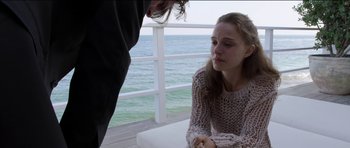 Movie still from “Knight of Cups” (2015), directed by Terrence Malick – A woman sitting next to a man on a pier; Medium shot, Over the shoulder angle