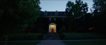 Movie still from “Knight of Cups” (2015), directed by Terrence Malick – A red door is lit up at night in front of a house; Extreme Wide shot, Low angle