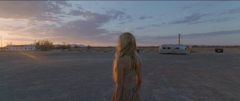 Movie still from “Knight of Cups” (2015), directed by Terrence Malick – A woman standing in the middle of an empty field; Wide shot, Over the shoulder angle