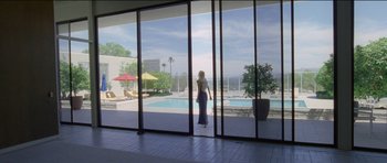 Movie still from “Knight of Cups” (2015), directed by Terrence Malick – A woman standing in front of an open sliding glass door; Extreme Wide shot, Low angle