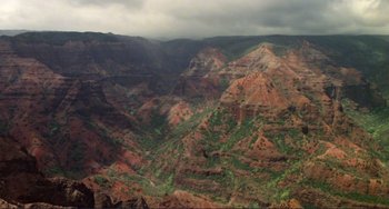 Movie still from “Koyaanisqatsi” (1982), directed by Godfrey Reggio – A view of a mountain range from a helicopter; Extreme Wide shot, High angle