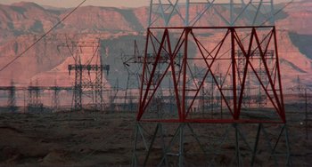 Movie still from “Koyaanisqatsi” (1982), directed by Godfrey Reggio – A view of power lines in the desert; Extreme Wide shot, High angle