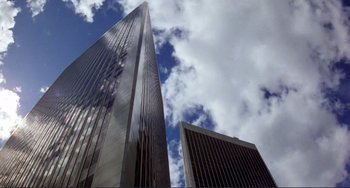 Movie still from “Koyaanisqatsi” (1982), directed by Godfrey Reggio – A view of a skyscraper from the ground looking up; Extreme Wide shot, Low angle