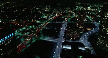 Movie still from “Koyaanisqatsi” (1982), directed by Godfrey Reggio – An aerial view of a city at night with street lights; Extreme Wide shot, High angle