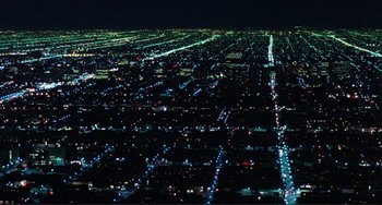 An aerial view of a city at night with many lights